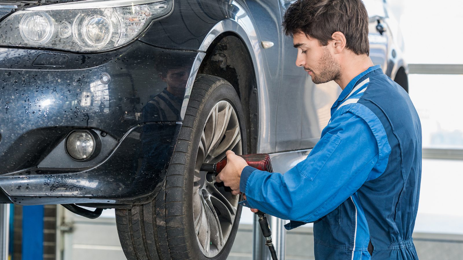 Mechanic using Compressed Air Gun