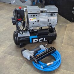 Photo taken from Metro Sales Air Compressor shop showing the PCL 8L air compressor on the floor grouped with a blue PVC air hose with safety coupling and a PCL Staple / Nail gun.