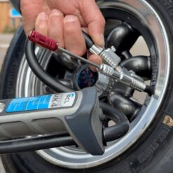 The Quick change tyre valve core removal tool being attached to a car tyre inflator