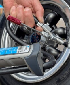 The Quick change tyre valve core removal tool being attached to a car tyre inflator